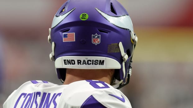 Sep 19, 2021; Glendale, Arizona, USA; An END RACISM sticker is shown on the helmet of Minnesota Vikings quarterback Kirk Cousins (8) prior to the game against the Arizona Cardinals at State Farm Stadium.